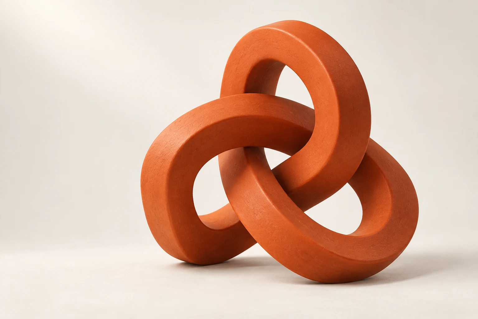 An intertwined orange sculpture representing ideas coming together